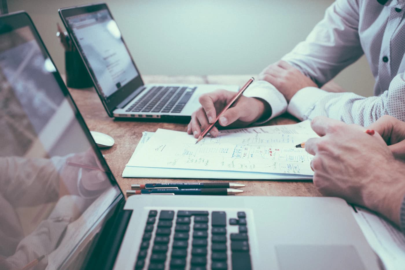 Reviewing investment figures with a laptop and calculator